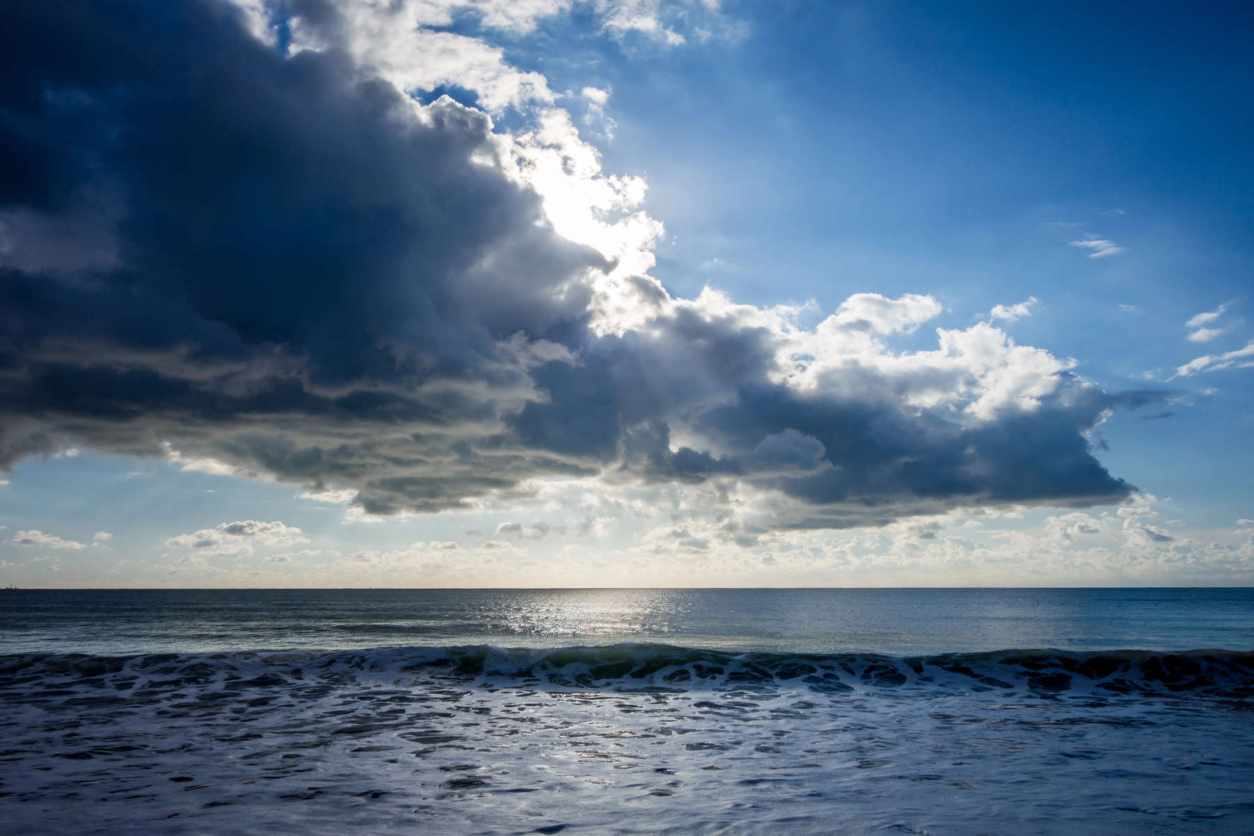 Beautiful cloudy seascape view from a beach at sunset