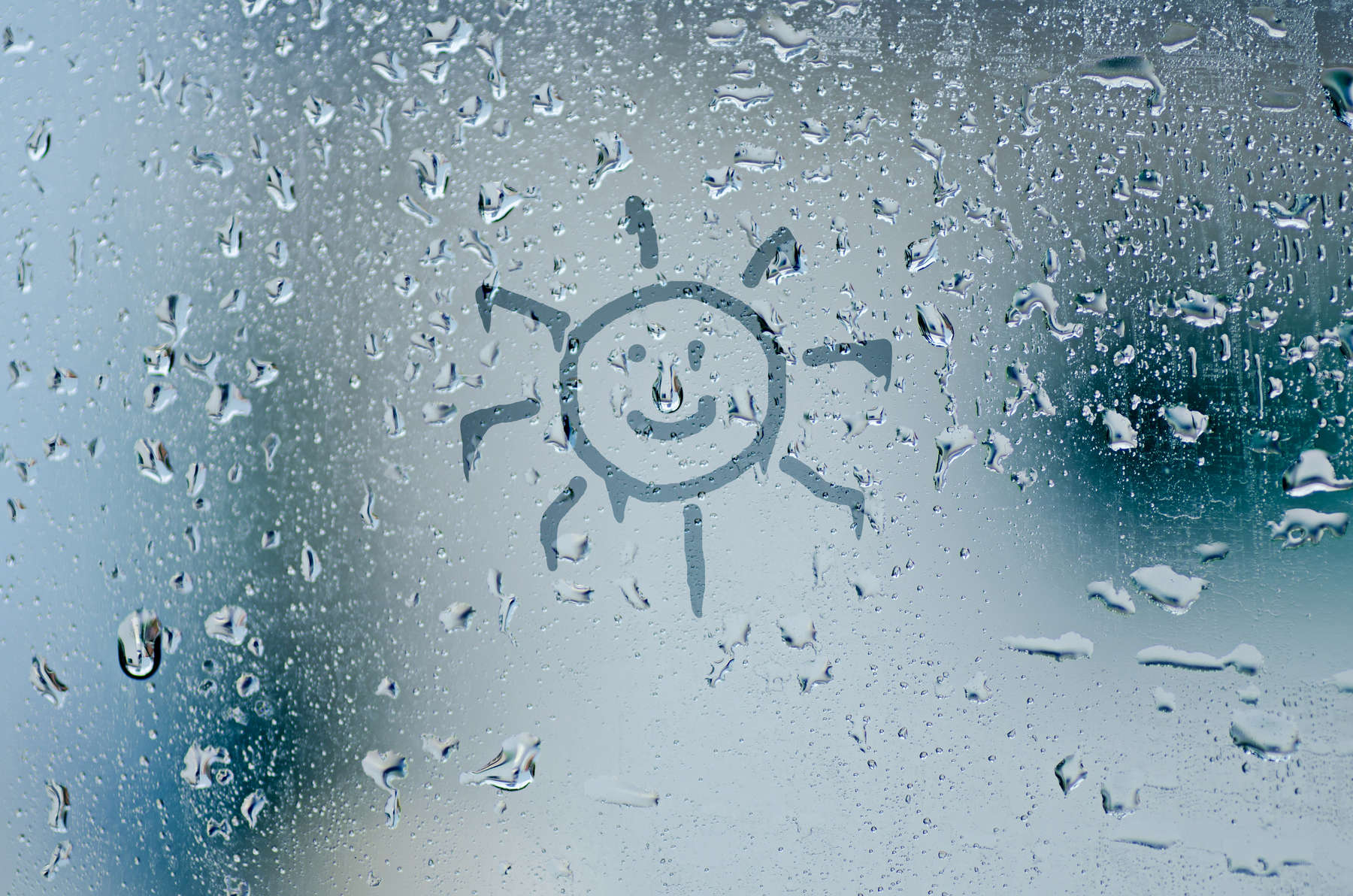sun sign on natural water drops on glass window background